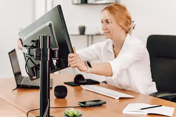 Person aligns the monitor.