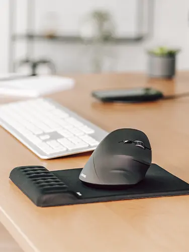 Ergonomic wireless mouse on the desk.